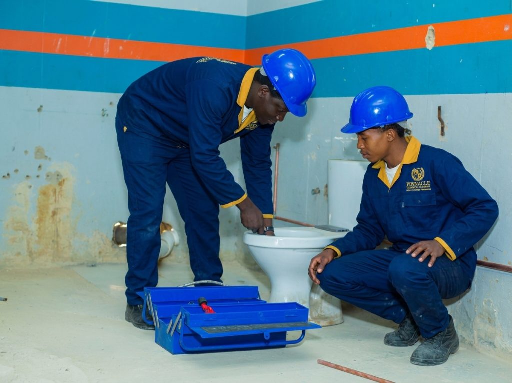 Students repairing toilet and drainage plumbing at Pinnacle Technical Academy Johannesburg