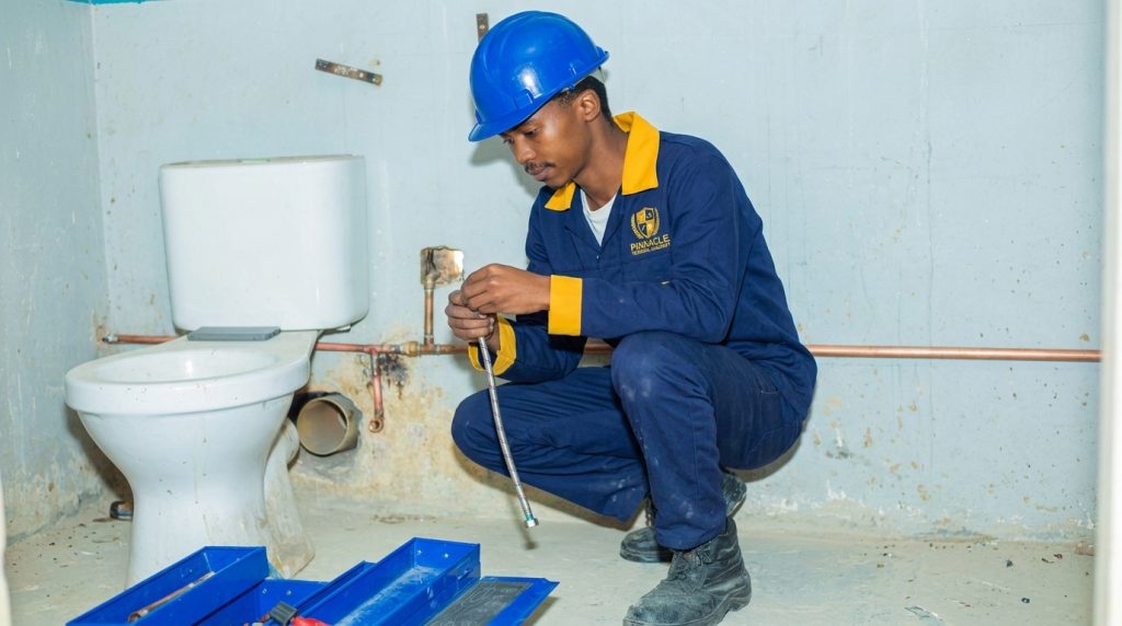 Plumbing hand student installing a toilet with an instructor at Pinnacle Technical Academy Johannesburg