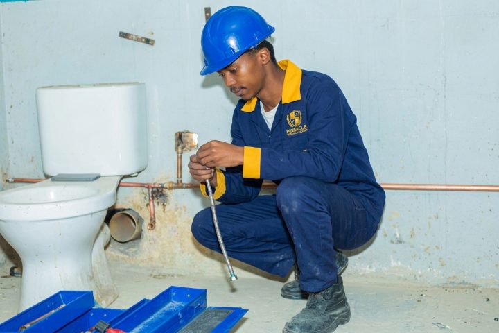Plumbing hand student installing a toilet with an instructor at Pinnacle Technical Academy Johannesburg