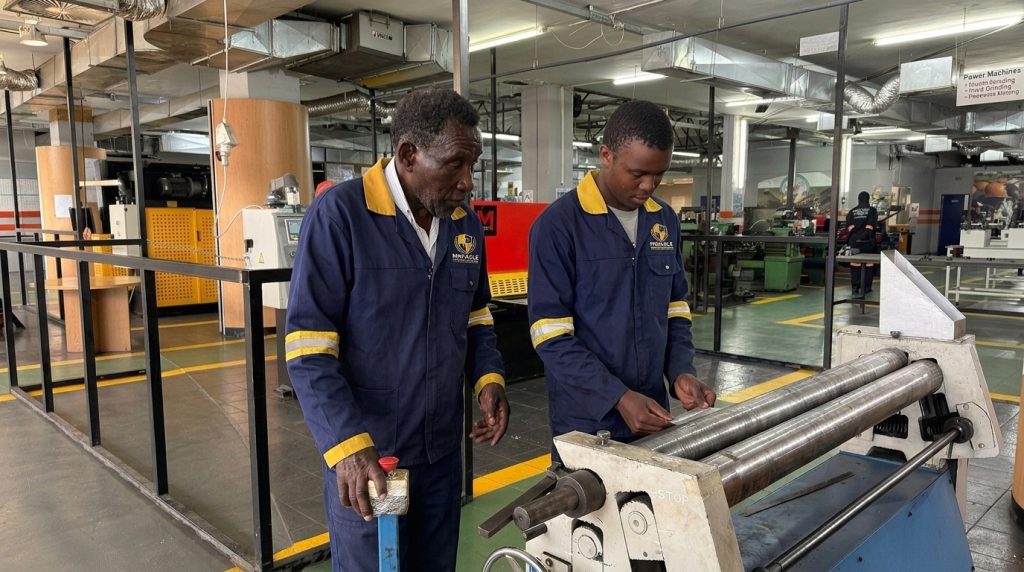 Boilermaker students using a plate rolling machine at Pinnacle Technical Academy Johannesburg