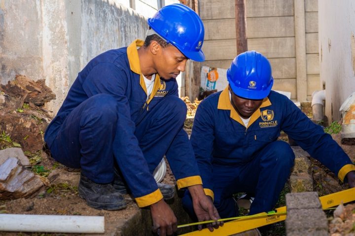 Bricklaying students checking brickwork with a spirit level at Pinnacle Technical Academy Johannesburg