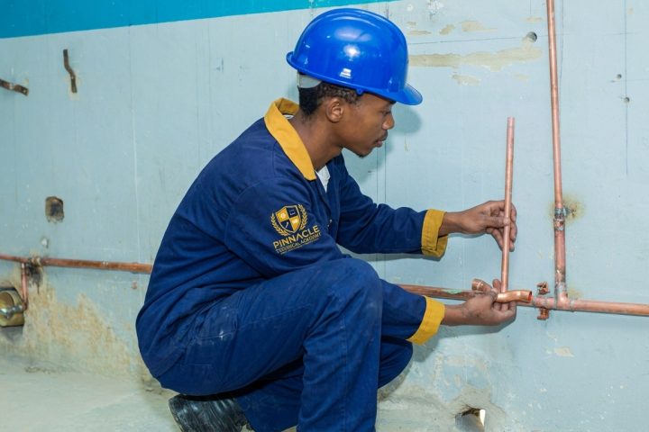 Pipe fitter student installing copper piping on a wall at Pinnacle Technical Academy Johannesburg