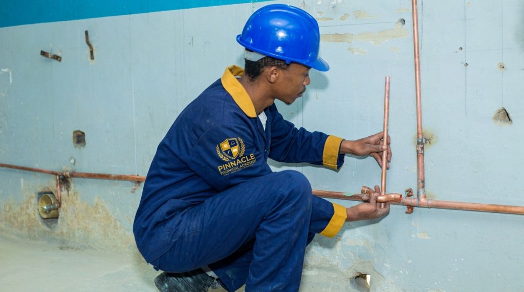 Plumbing student fitting copper water pipes during trade training at Pinnacle Technical Academy Johannesburg