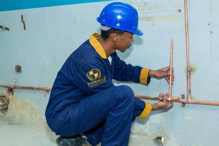 Plumbing student fitting copper water pipes during trade training at Pinnacle Technical Academy Johannesburg
